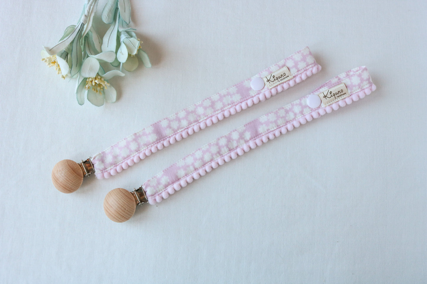 pink dummy clip with pompom trim