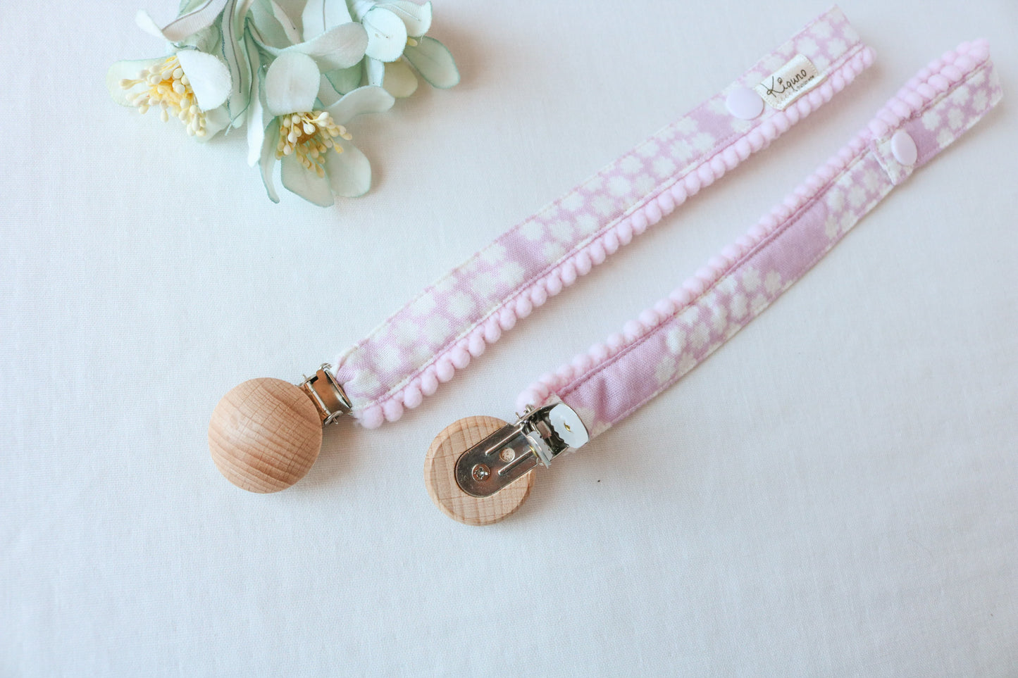 pink dummy clip with pompom trim